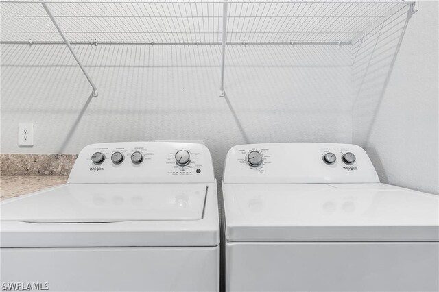 washroom with washing machine and clothes dryer