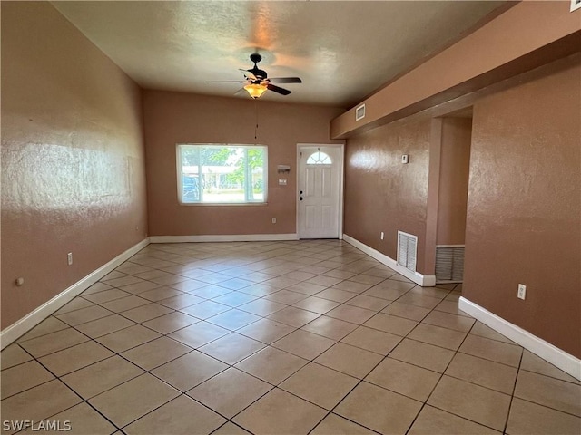 tiled foyer entrance featuring ceiling fan