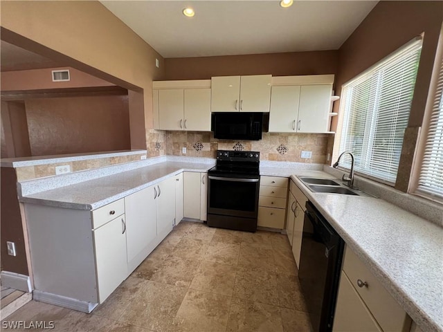 kitchen featuring sink, backsplash, white cabinetry, and black appliances