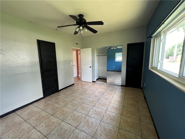 unfurnished bedroom featuring ceiling fan and light tile patterned floors