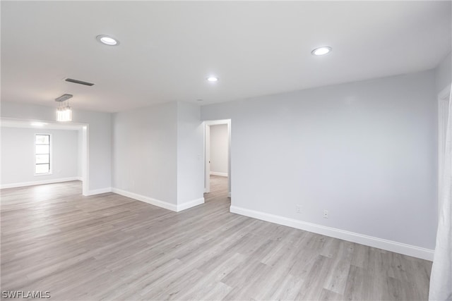 empty room with light hardwood / wood-style flooring