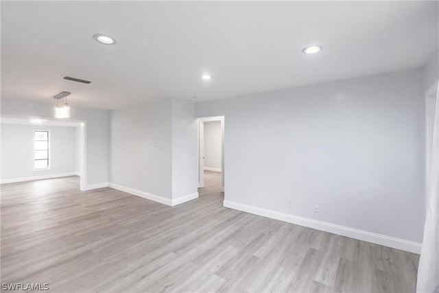 spare room featuring light hardwood / wood-style floors