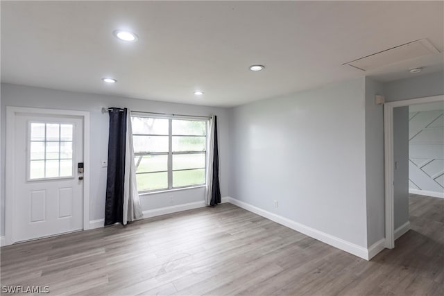 spare room featuring hardwood / wood-style floors and plenty of natural light