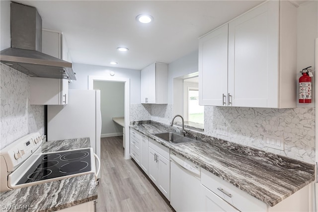 kitchen featuring wall chimney range hood, sink, white appliances, and backsplash