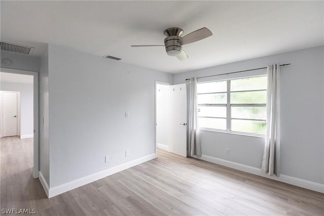 unfurnished room featuring light hardwood / wood-style floors and ceiling fan