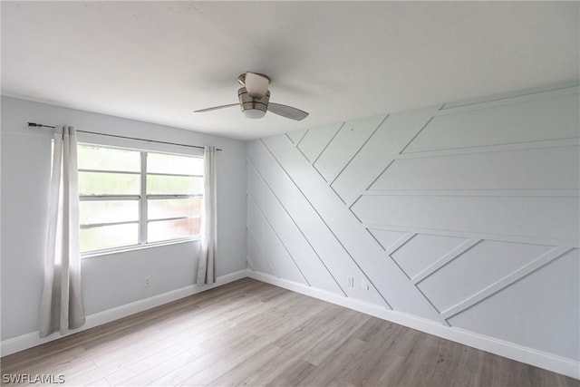 spare room with hardwood / wood-style flooring and ceiling fan