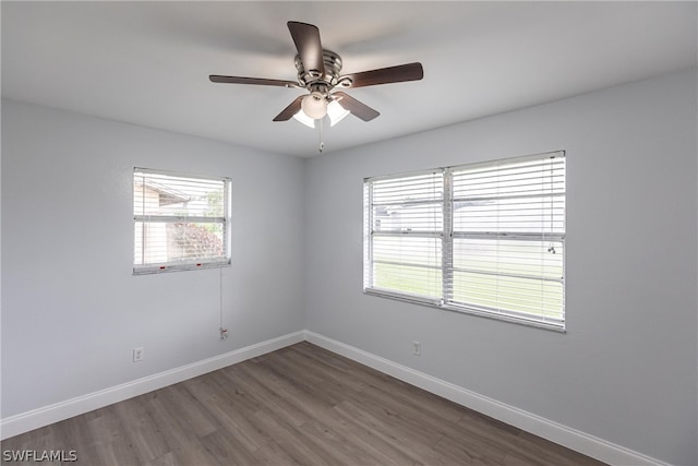 unfurnished room with wood-type flooring, a wealth of natural light, and ceiling fan