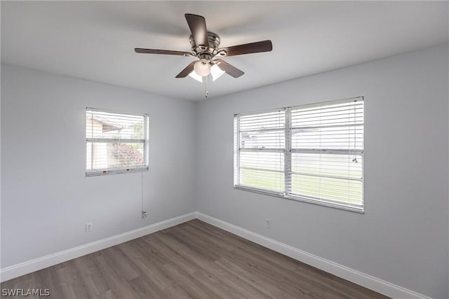 unfurnished room featuring dark wood-type flooring and ceiling fan