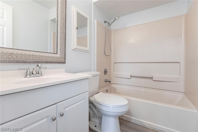 full bathroom with tub / shower combination, vanity, hardwood / wood-style flooring, and toilet