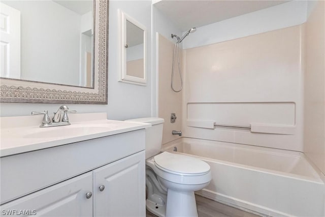 full bathroom with shower / bathing tub combination, vanity, hardwood / wood-style flooring, and toilet