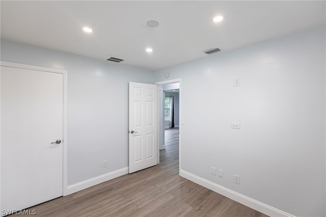 unfurnished room with light hardwood / wood-style flooring