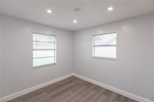 empty room with dark hardwood / wood-style flooring