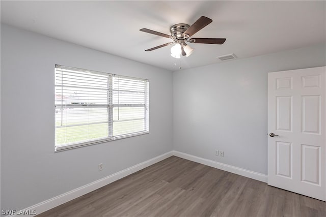 empty room featuring hardwood / wood-style floors and ceiling fan