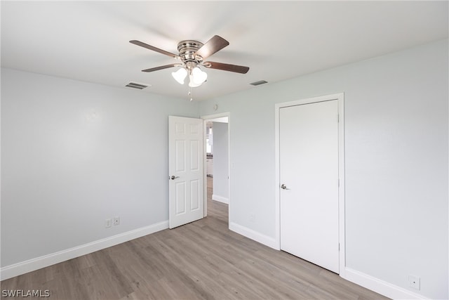 unfurnished bedroom featuring light wood-type flooring and ceiling fan