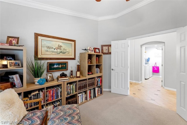 sitting room featuring crown molding and light tile patterned flooring