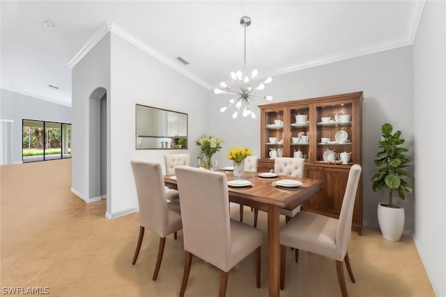 tiled dining space with a chandelier, lofted ceiling, and ornamental molding