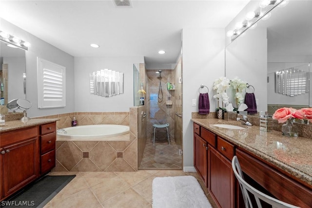full bathroom featuring a garden tub, vanity, a shower stall, and tile patterned floors
