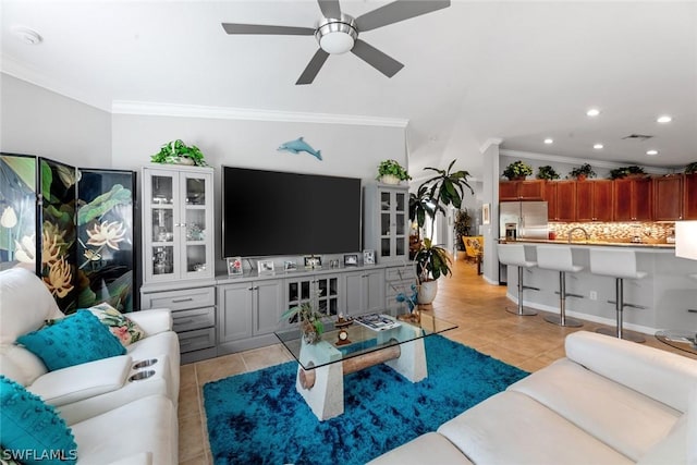 living room with ceiling fan, light tile patterned flooring, and ornamental molding