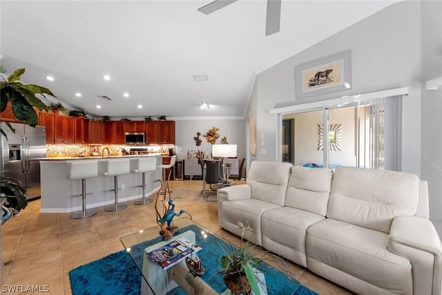 living room featuring light tile patterned floors, vaulted ceiling, ceiling fan, and crown molding