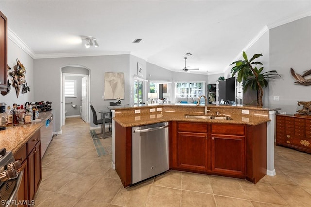 kitchen with light stone counters, stainless steel appliances, crown molding, sink, and a center island with sink