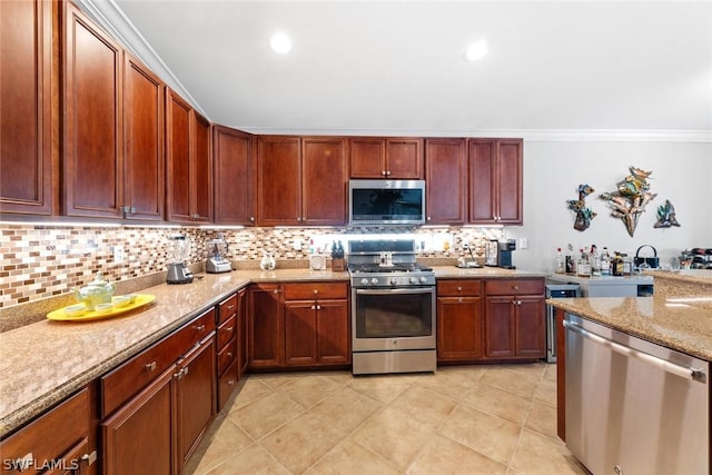 kitchen featuring light stone countertops, appliances with stainless steel finishes, decorative backsplash, and ornamental molding