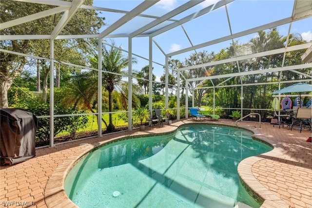 view of pool featuring a lanai, a patio, and grilling area