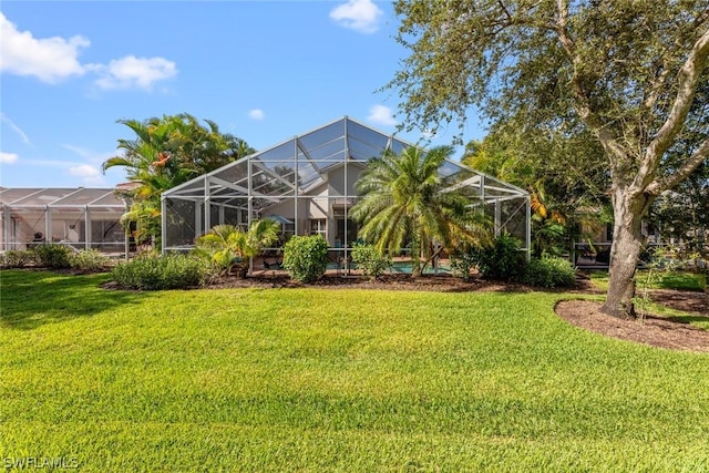 view of yard with glass enclosure