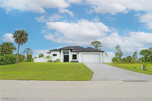 view of front of house featuring a front yard and a garage