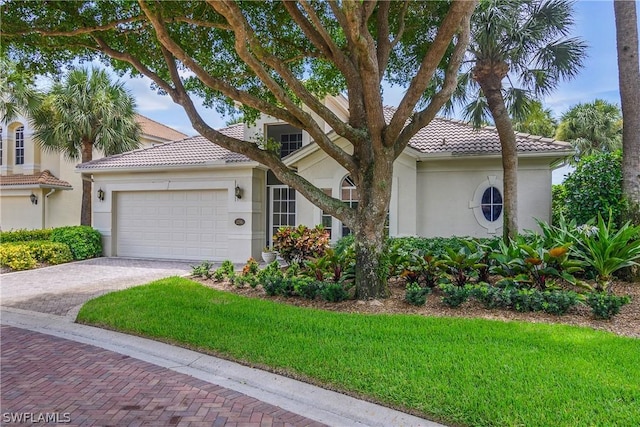 view of front of property with a garage and a front lawn