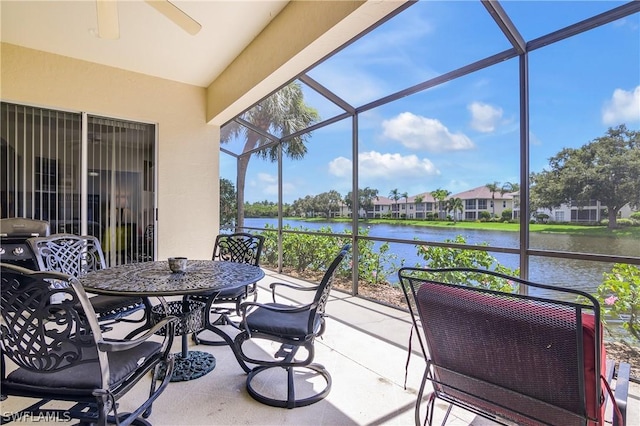 sunroom featuring a water view, a wealth of natural light, and ceiling fan