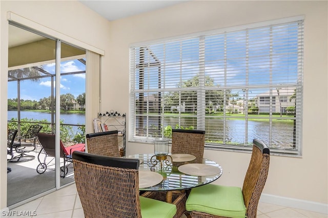 tiled dining area featuring a water view