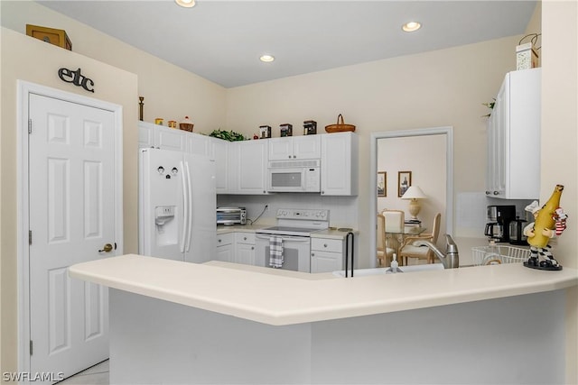 kitchen with white cabinetry, white appliances, kitchen peninsula, and decorative backsplash