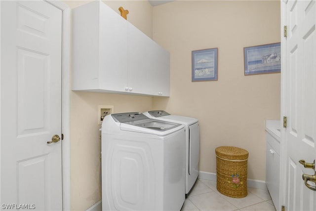 washroom featuring light tile patterned flooring, cabinets, and separate washer and dryer