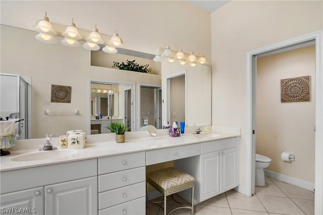 bathroom featuring vanity, tile patterned floors, and toilet