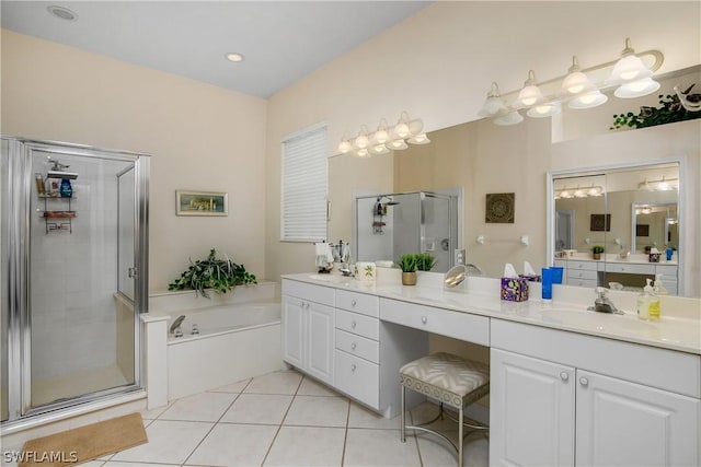 bathroom featuring tile patterned flooring, shower with separate bathtub, and vanity