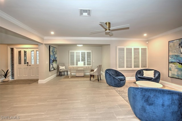 sitting room with ceiling fan and ornamental molding