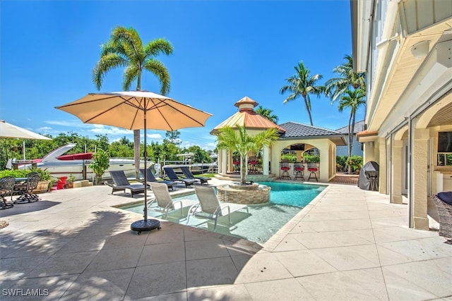 view of swimming pool with a patio area and a gazebo