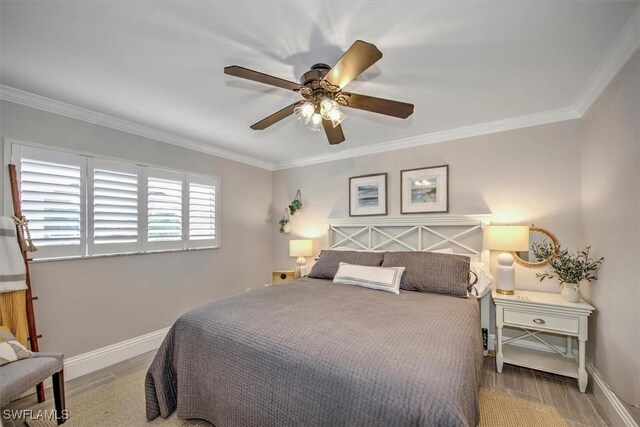 bedroom featuring ceiling fan, hardwood / wood-style flooring, and crown molding