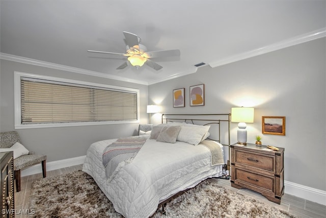 bedroom featuring ceiling fan, crown molding, and hardwood / wood-style floors