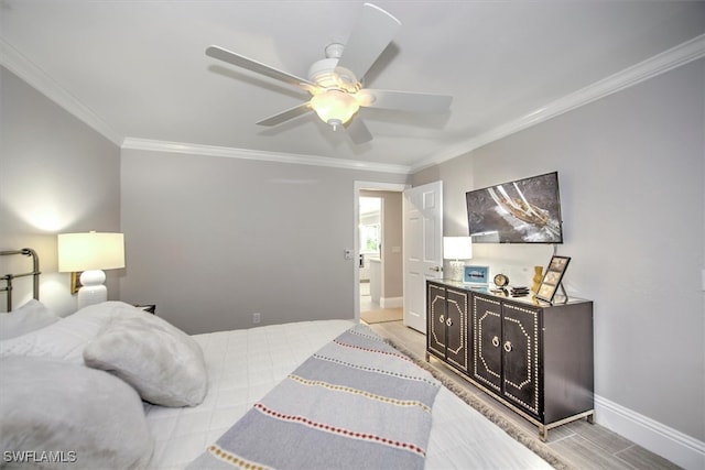 bedroom featuring ceiling fan, hardwood / wood-style flooring, and crown molding