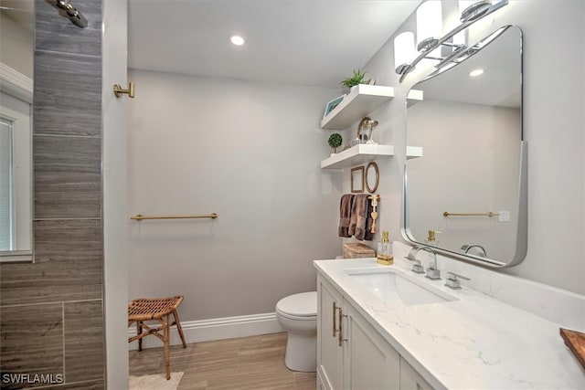 bathroom with hardwood / wood-style flooring, vanity, and toilet