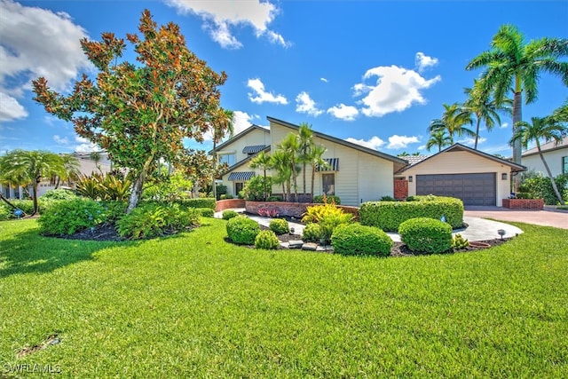 view of front facade with a garage and a front lawn