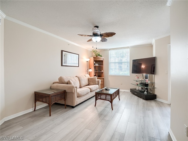 living room featuring ceiling fan, light hardwood / wood-style floors, a textured ceiling, and ornamental molding