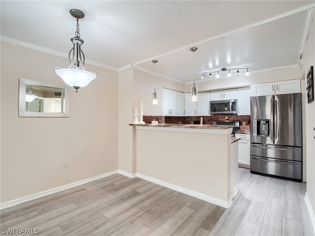 kitchen featuring light hardwood / wood-style flooring, kitchen peninsula, pendant lighting, white cabinets, and appliances with stainless steel finishes