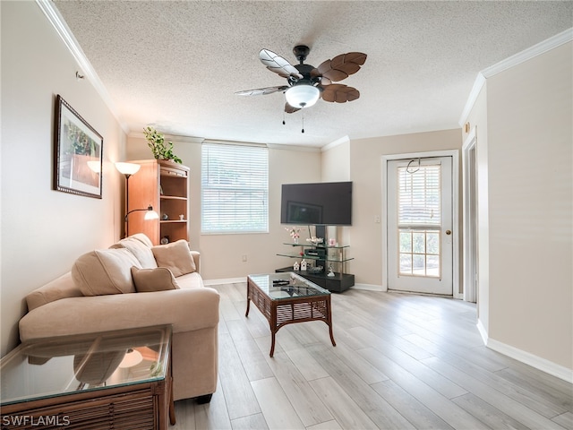 living room with crown molding, a wealth of natural light, and light hardwood / wood-style flooring