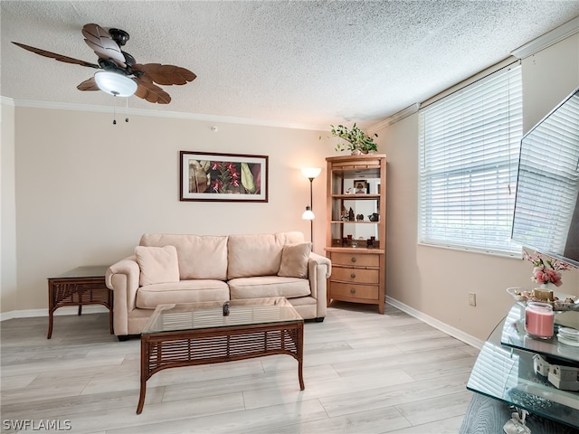 living room with a textured ceiling, ceiling fan, light hardwood / wood-style floors, and crown molding