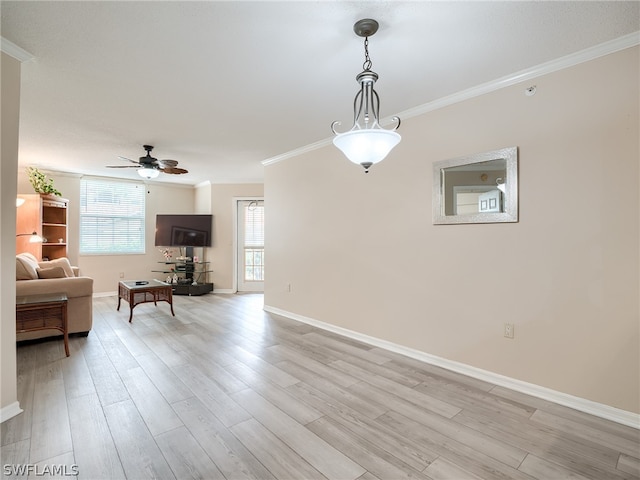 unfurnished living room featuring ceiling fan, light wood-type flooring, and ornamental molding