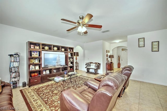 tiled living room featuring ceiling fan