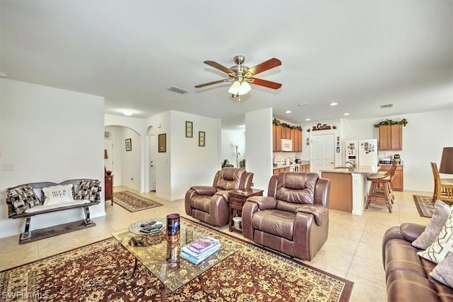 tiled living room featuring ceiling fan