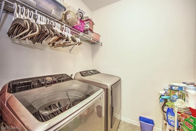 laundry room featuring tile patterned floors and washing machine and clothes dryer